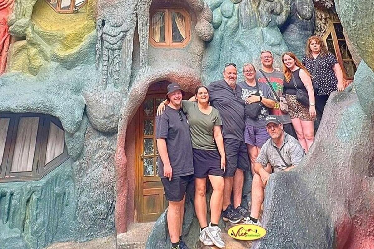 a group of people posing for a picture in front of a castle