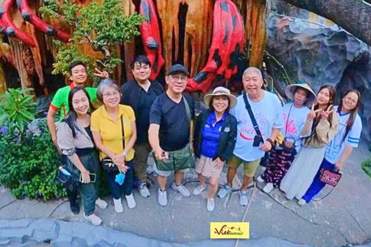 a group of people posing for a picture in front of a wall