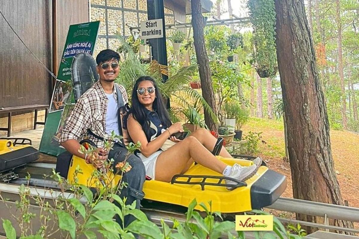 a man and a woman sitting on a toy car