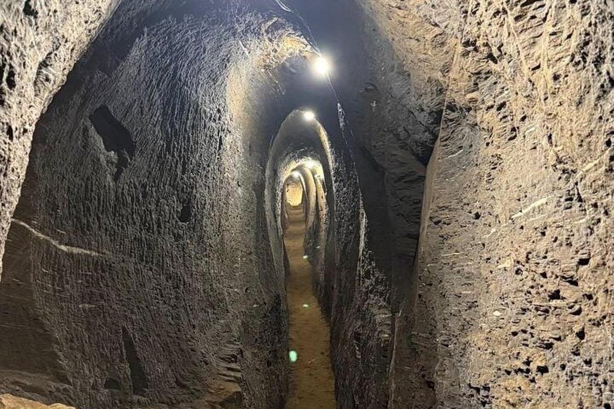 a dark tunnel with two tunnels with water in it