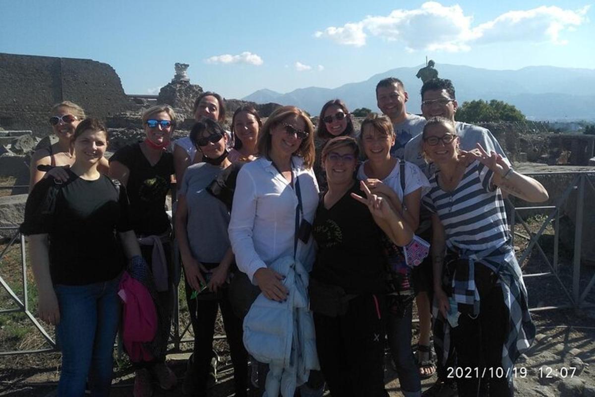 a group of people posing for a picture on top of a pyramid