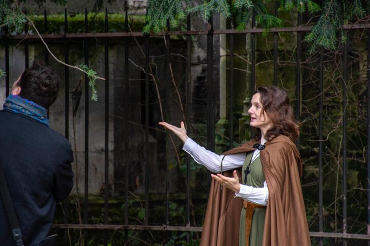 a man and a woman standing in front of a fence