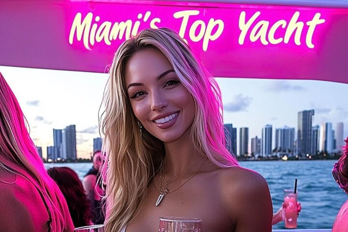 a woman with pink hair standing in front of a boat