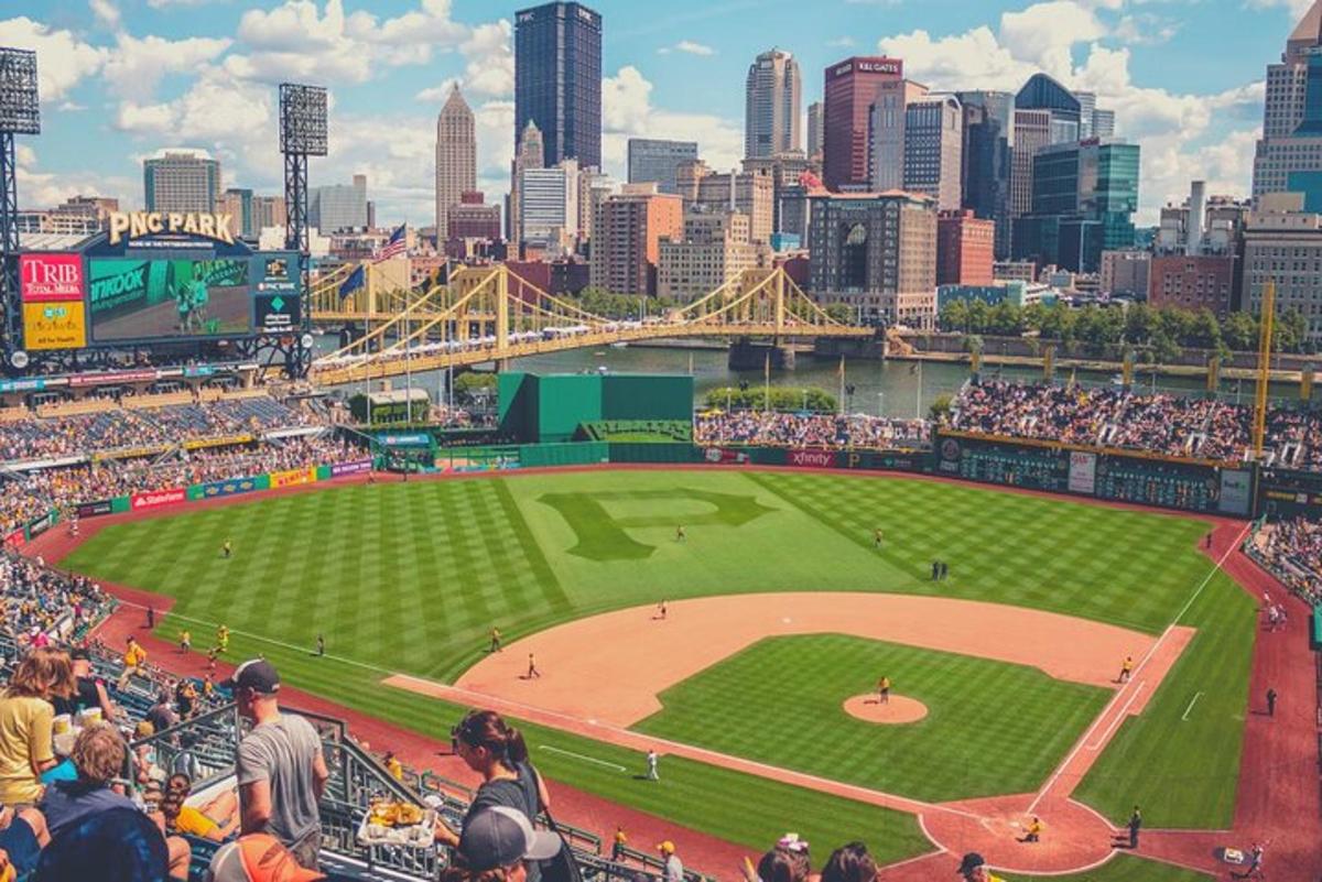 a crowd of people watching a baseball game at a stadium