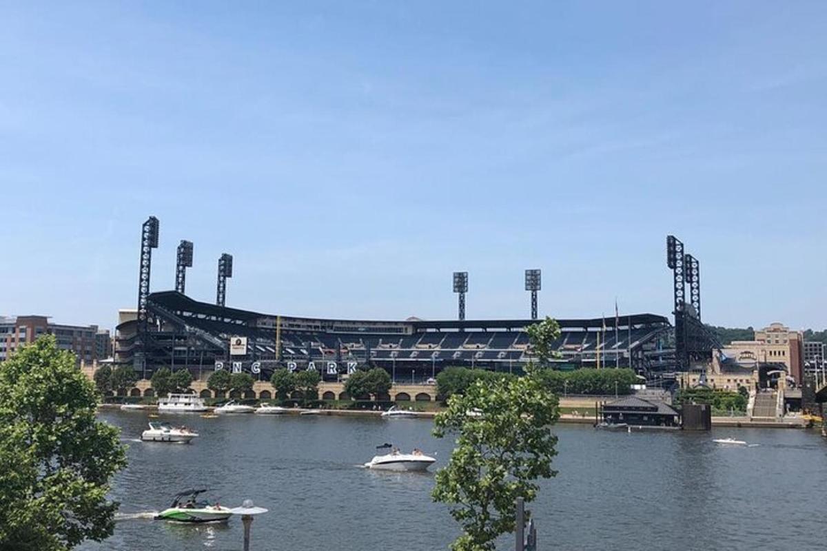 a view of a baseball stadium with boats in the water