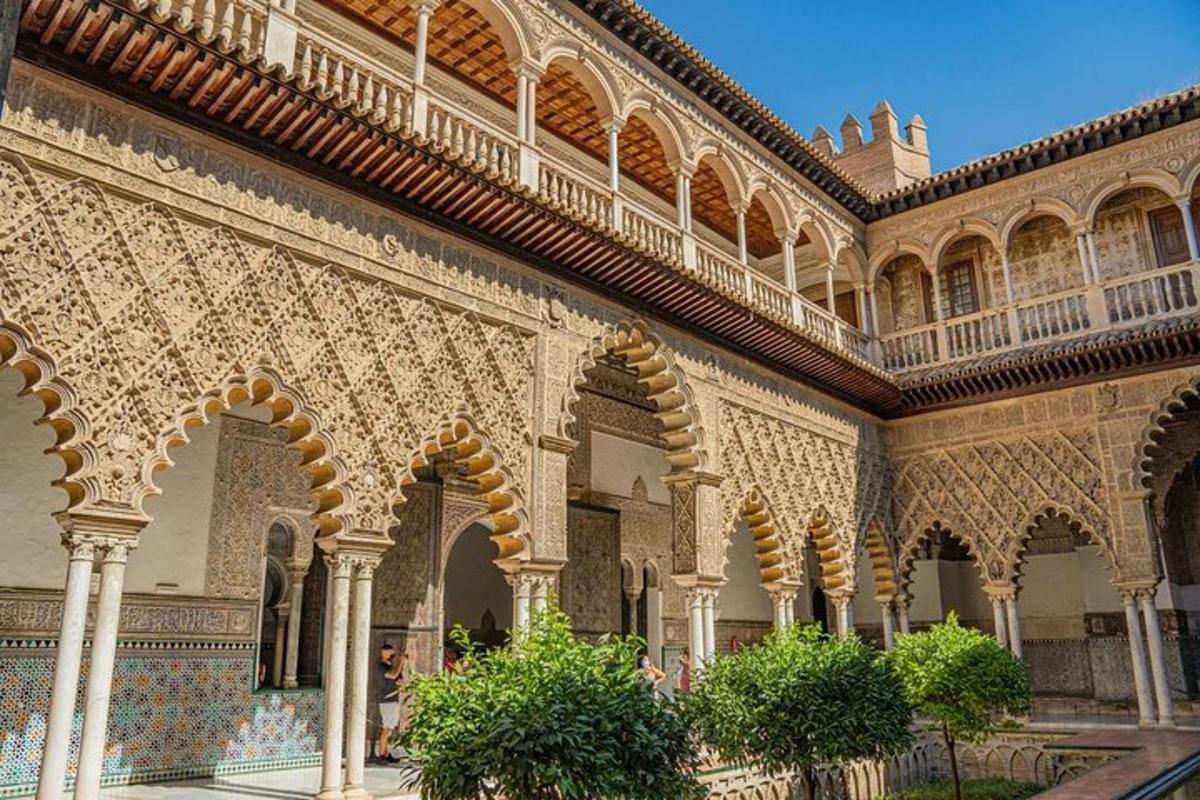 a building with ornate architecture with trees in the courtyard