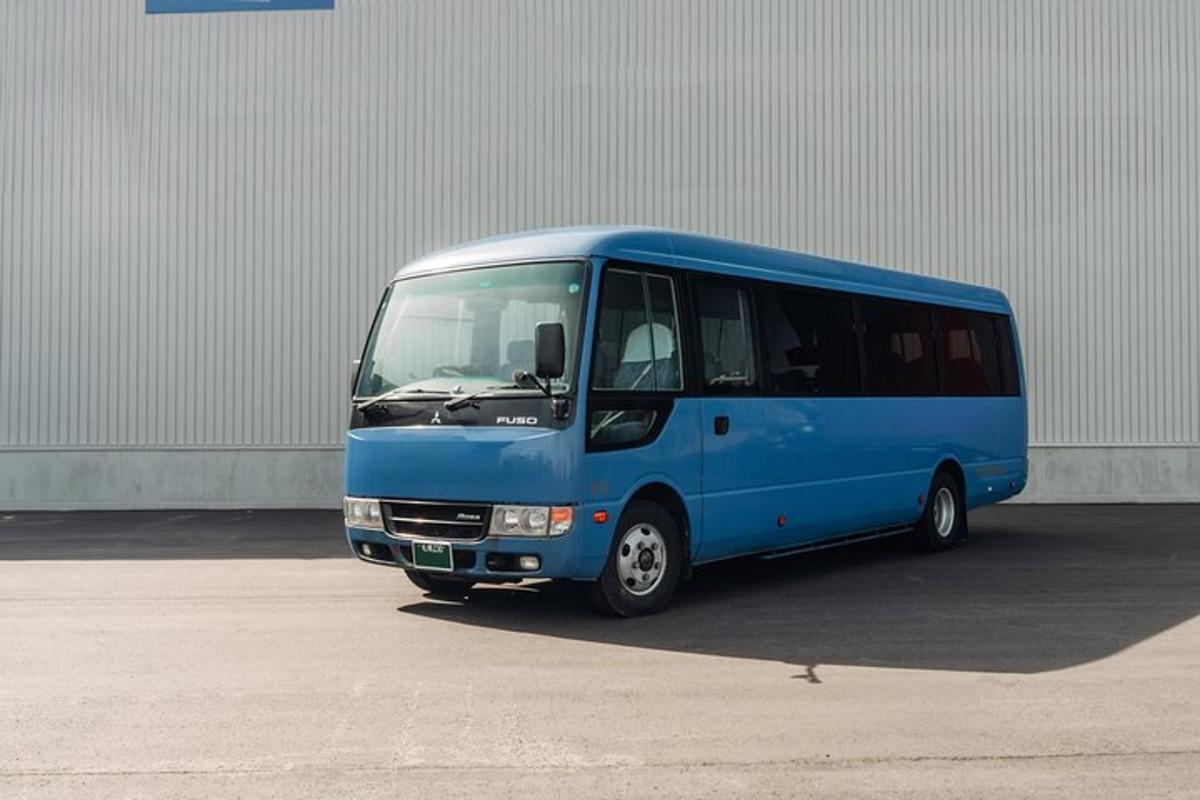 a blue bus parked in front of a building