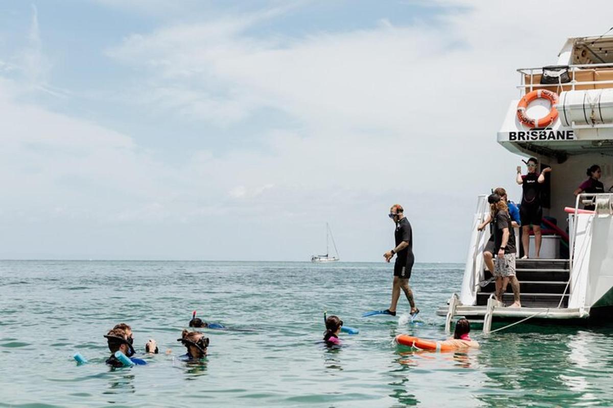 a group of people in the water next to a boat