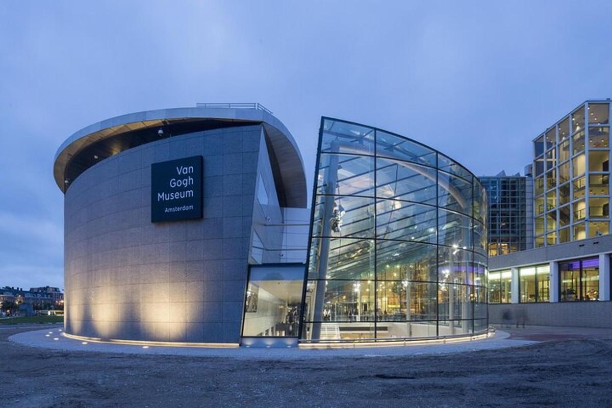 a glass building with a sign in front of it