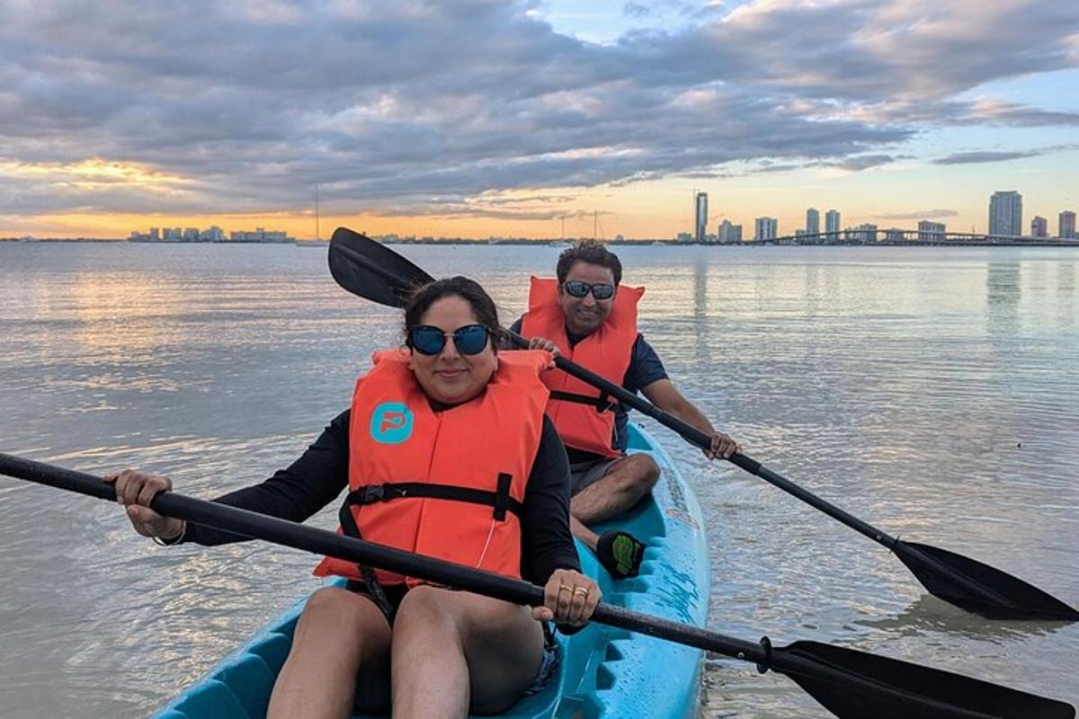 two people are in a kayak on the water