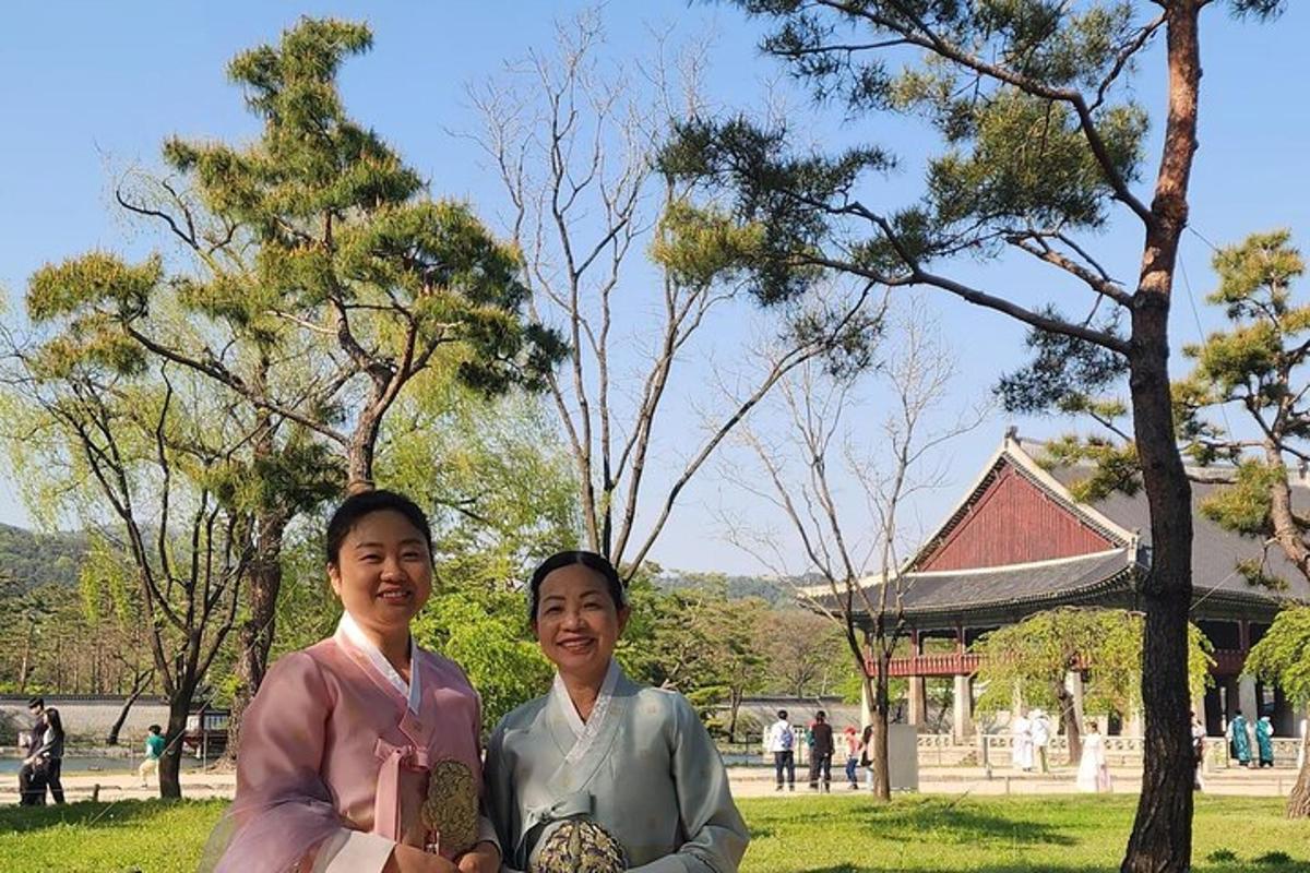two women posing for a picture in a park