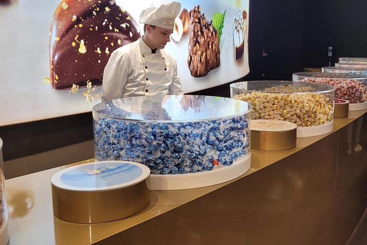 a chef standing in front of a display of food