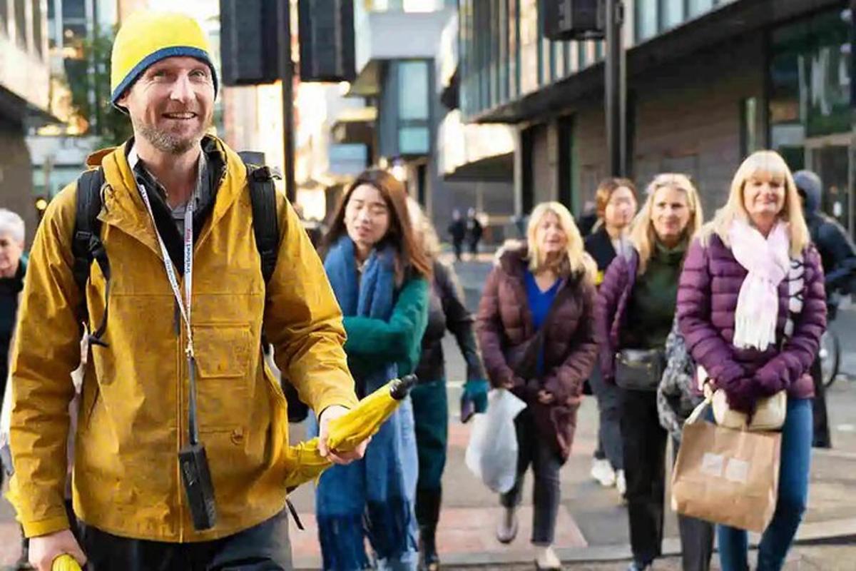 a man walking down a street with a group of people