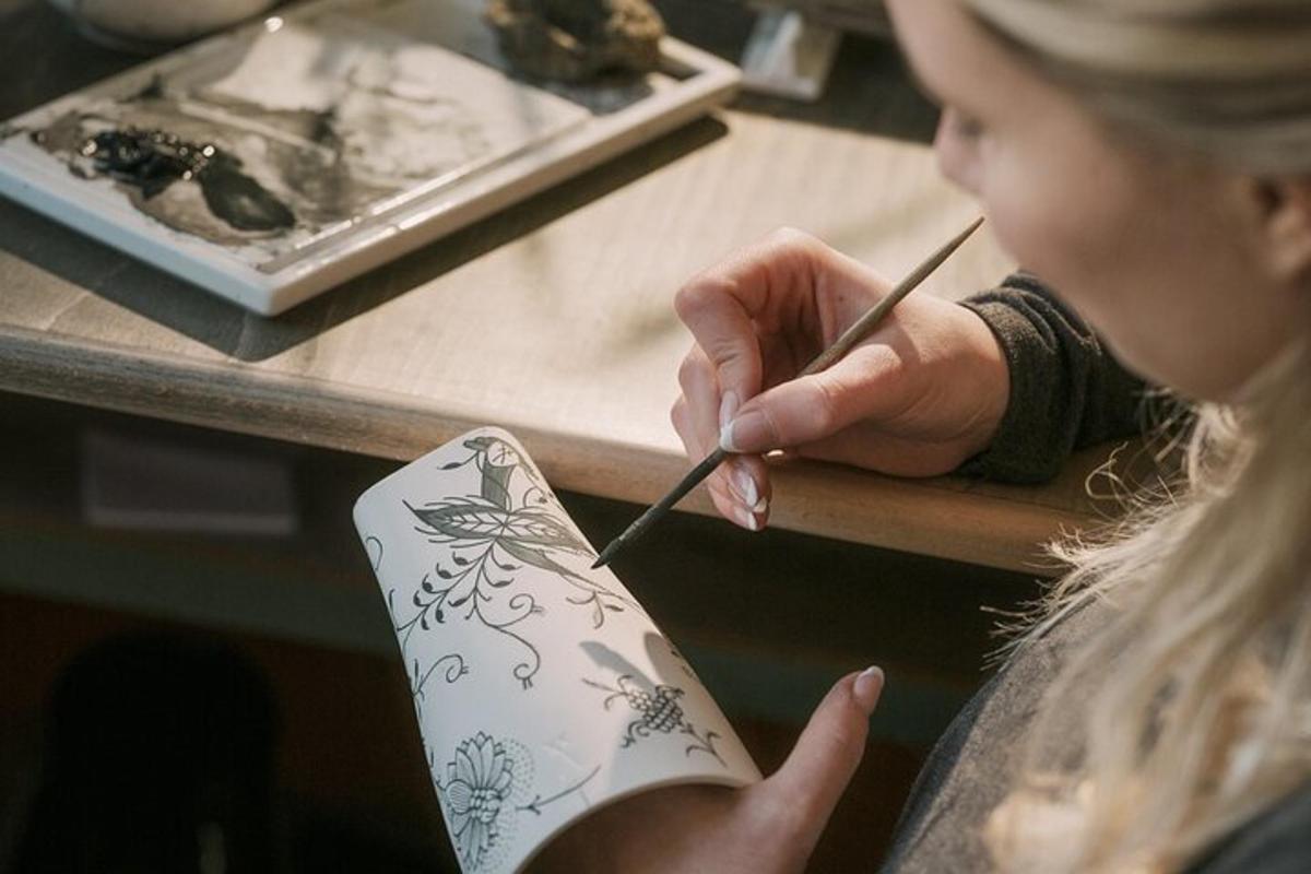 a woman cutting a piece of paper with a pencil