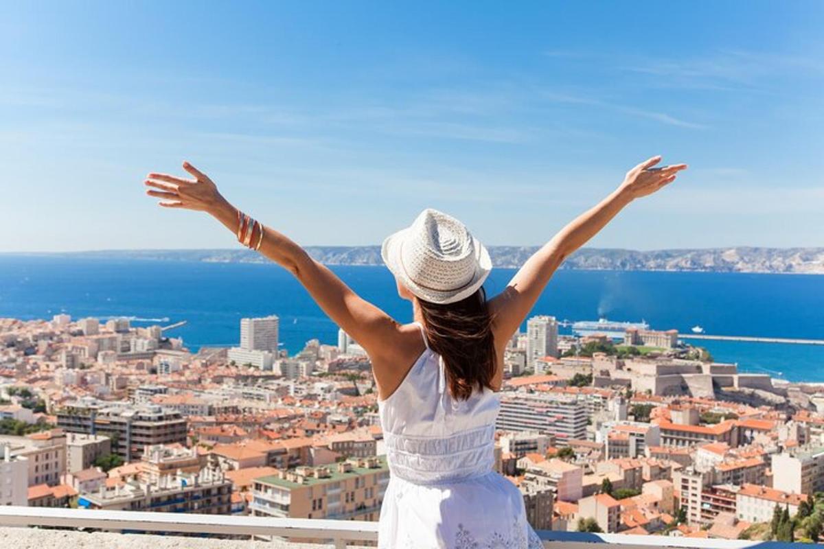 a woman standing on top of a building with her arms outstretched