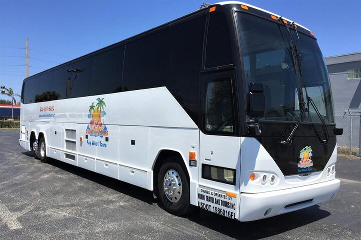 a black and white bus parked in a parking lot
