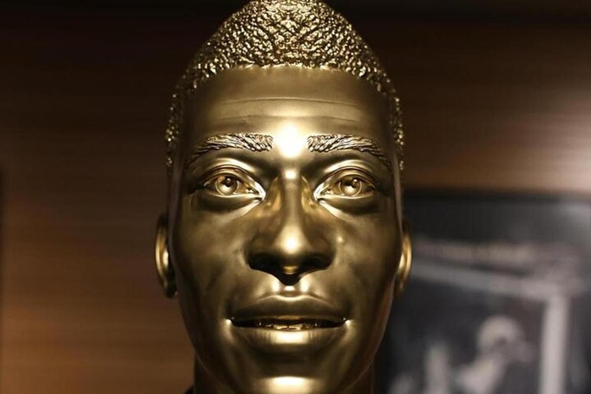 a gold head of a statue of a woman