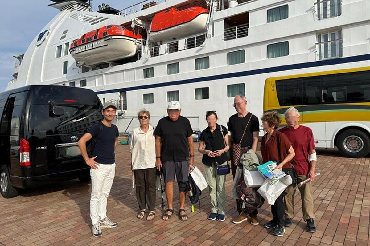 a group of people standing in front of a cruise ship