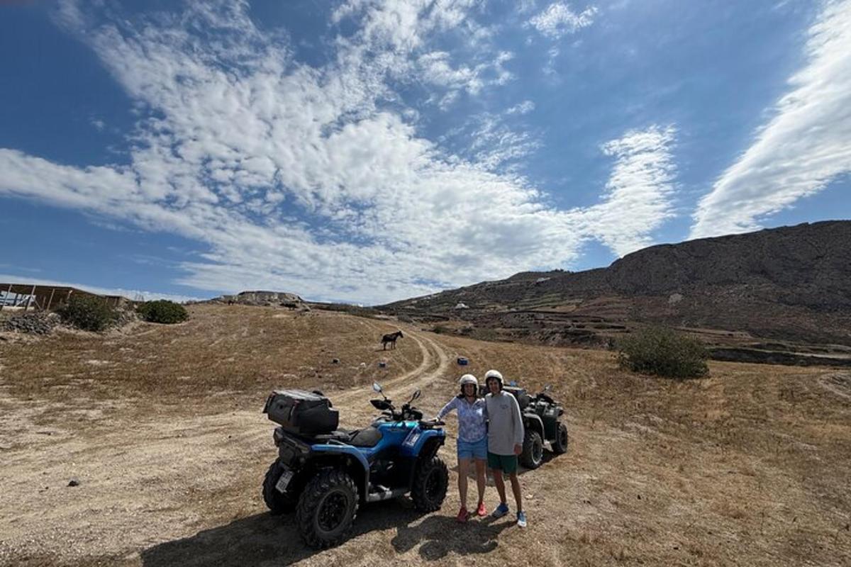 Un grupo de personas de pie junto a una motocicleta en un camino de tierra.