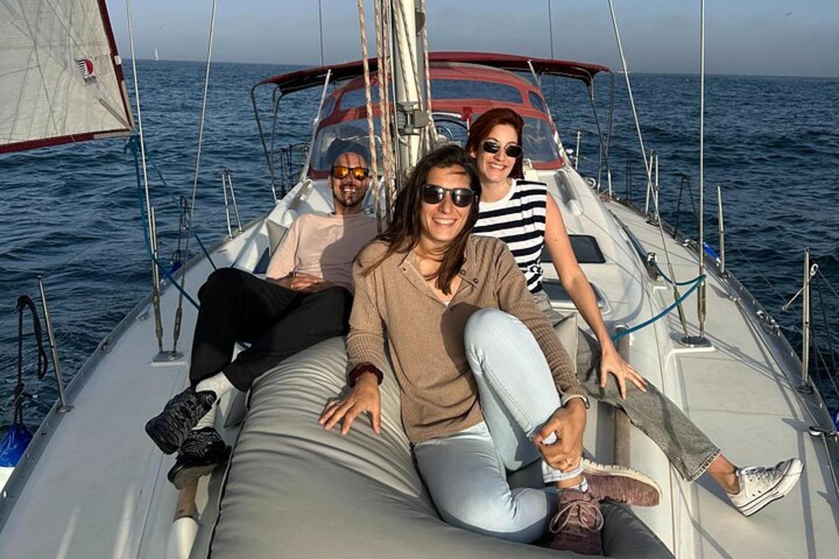 three people sitting on a boat in the water