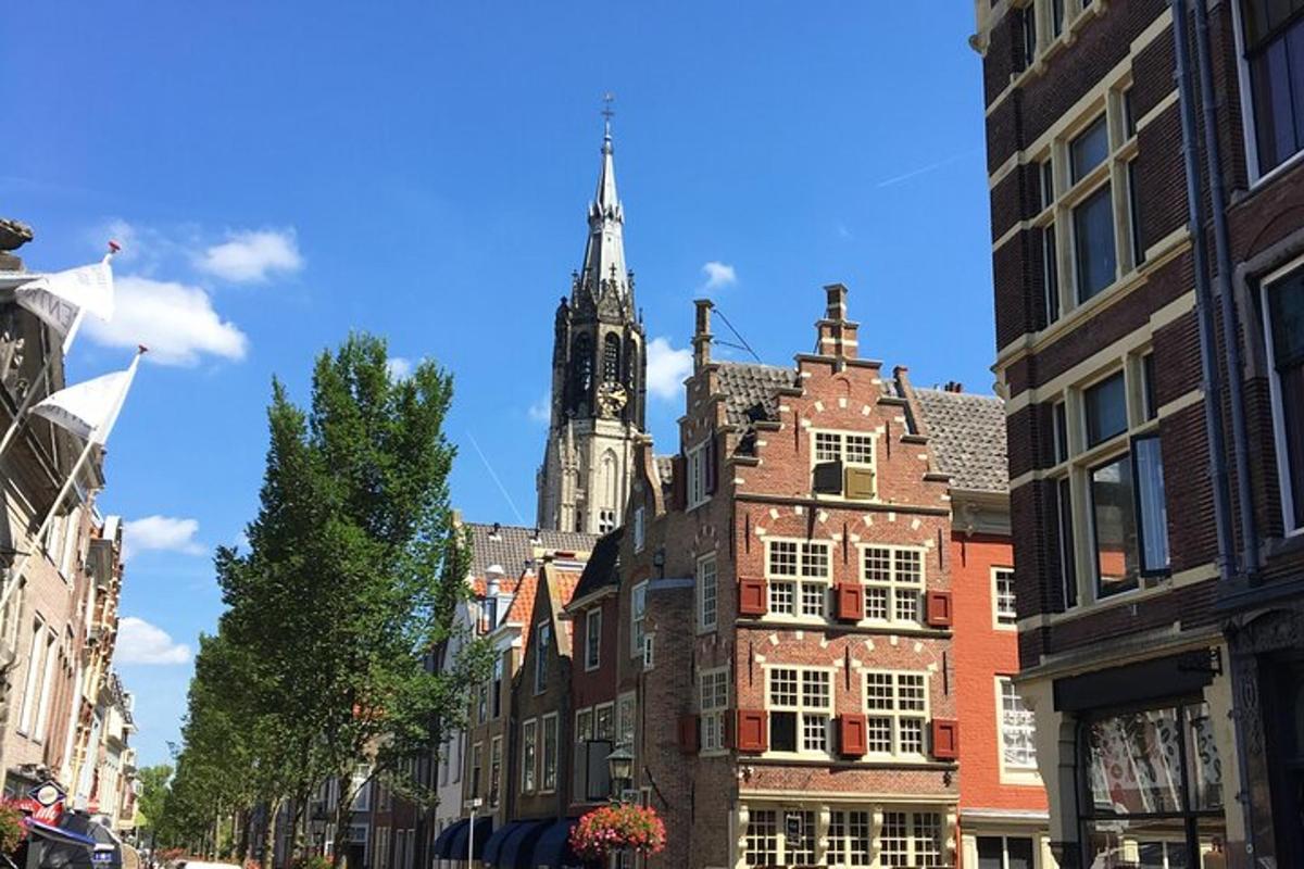 a city street with buildings and a church tower