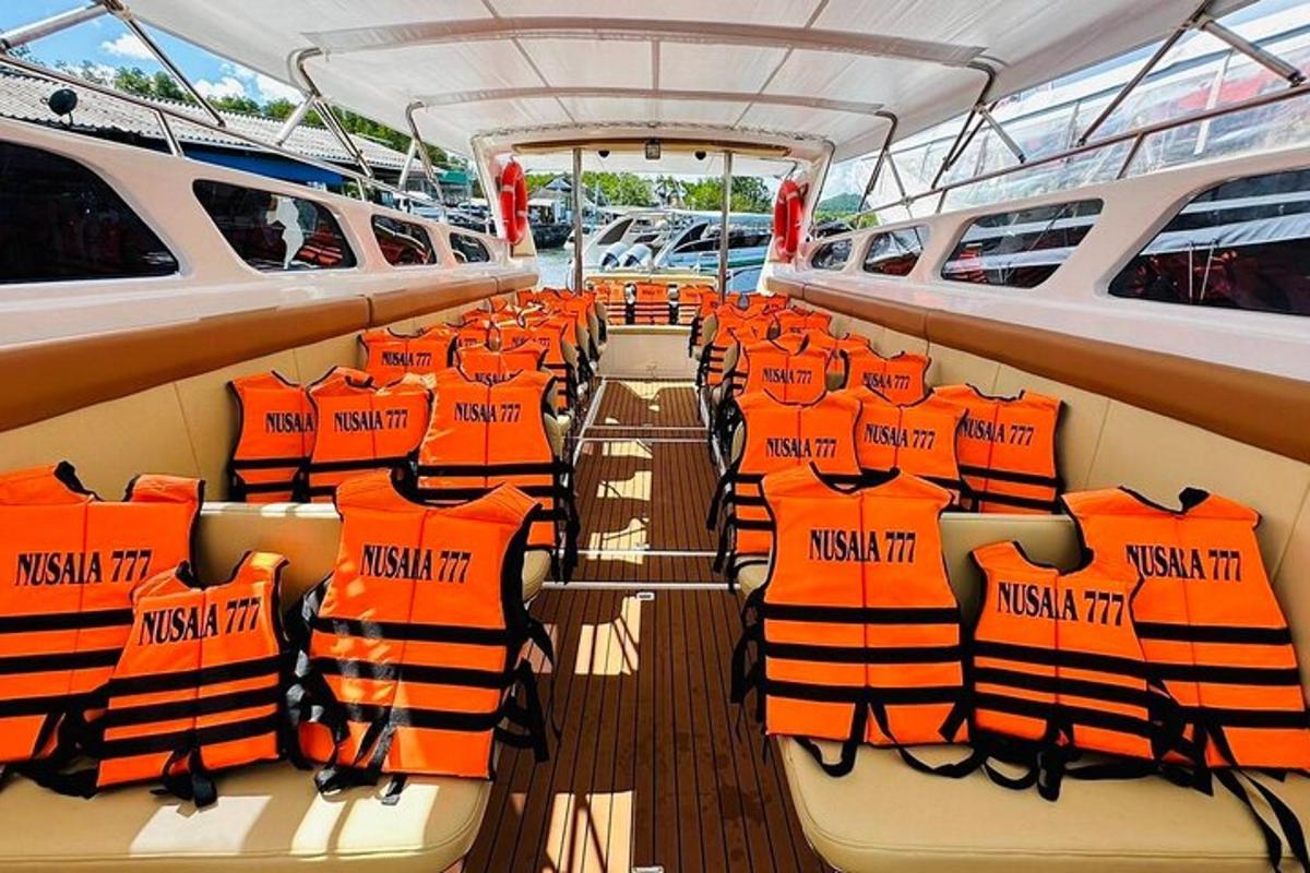 a boat with orange life jackets on the deck