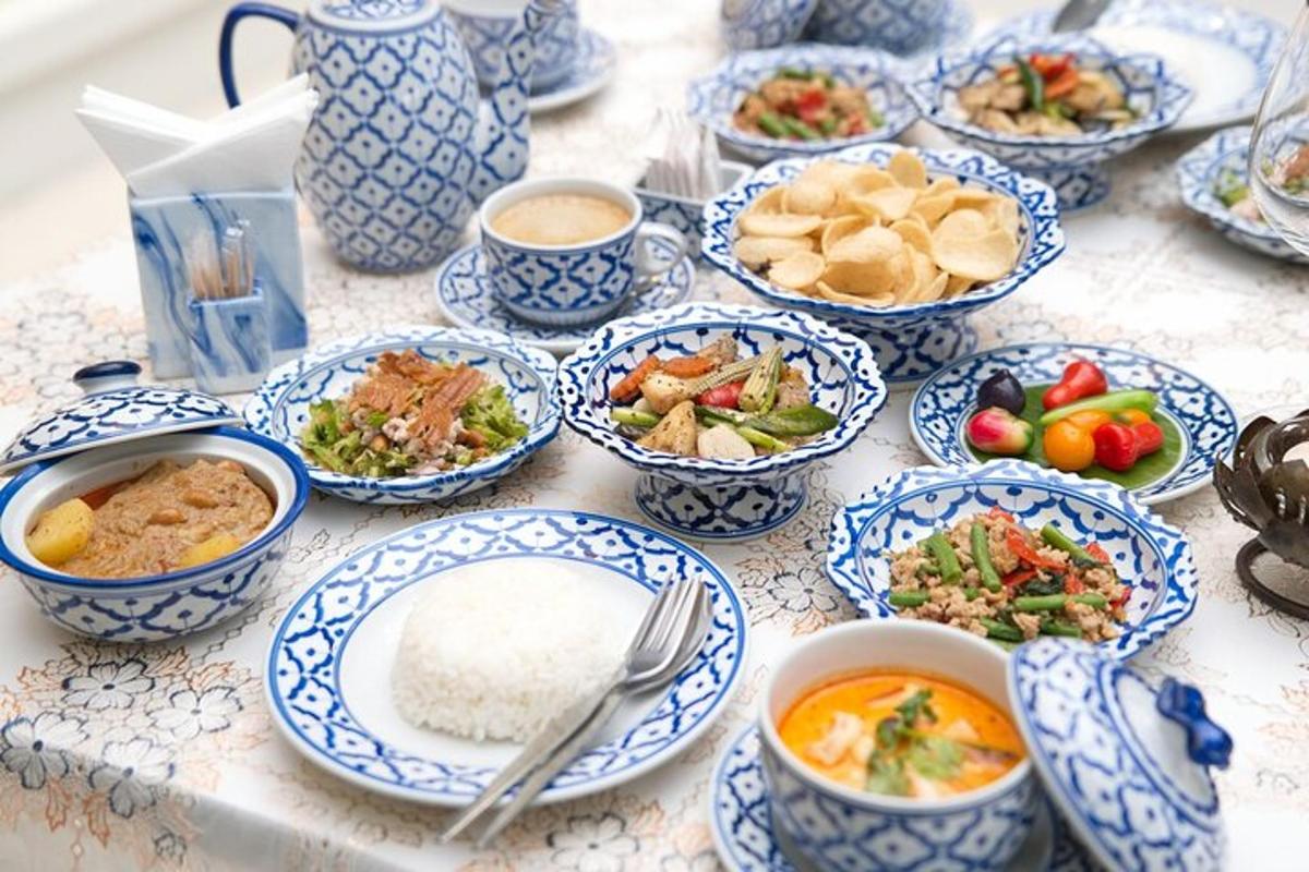 a table topped with blue and white dishes of food