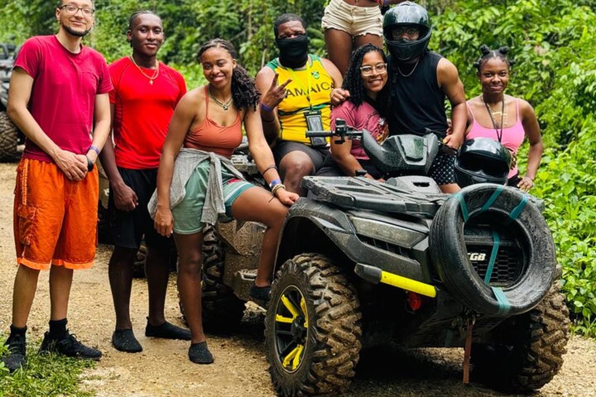 a group of people posing for a picture on a four wheeler