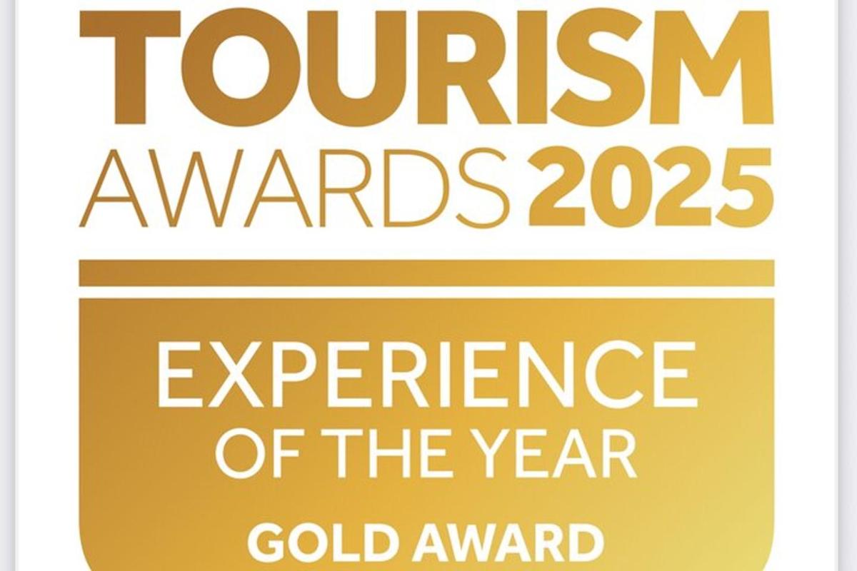 a sign that reads tourism awards experience of the year gold award