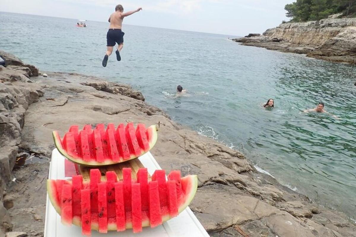 muž skákající z lodi s plátky melounu
