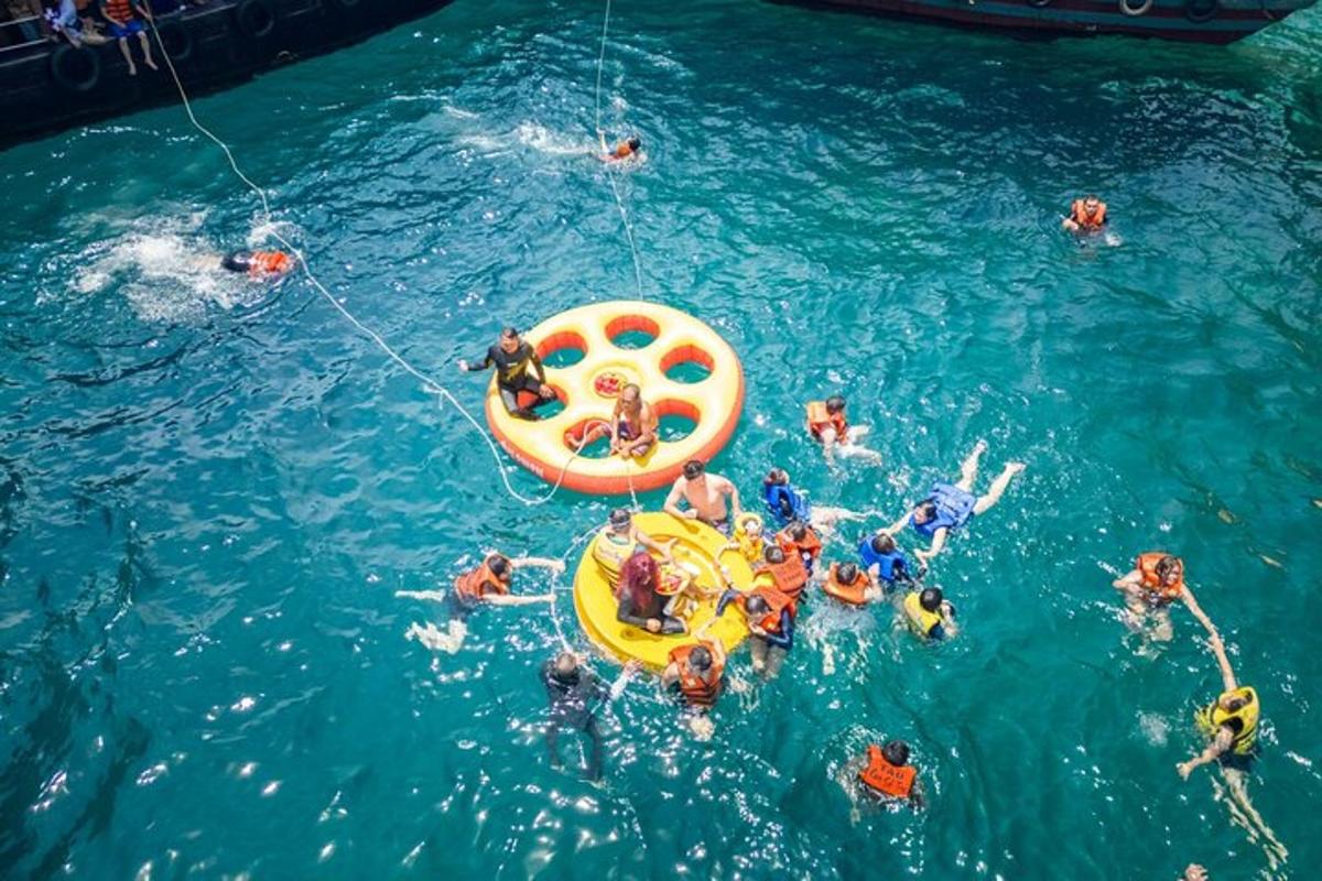 a group of people in the water at a pool
