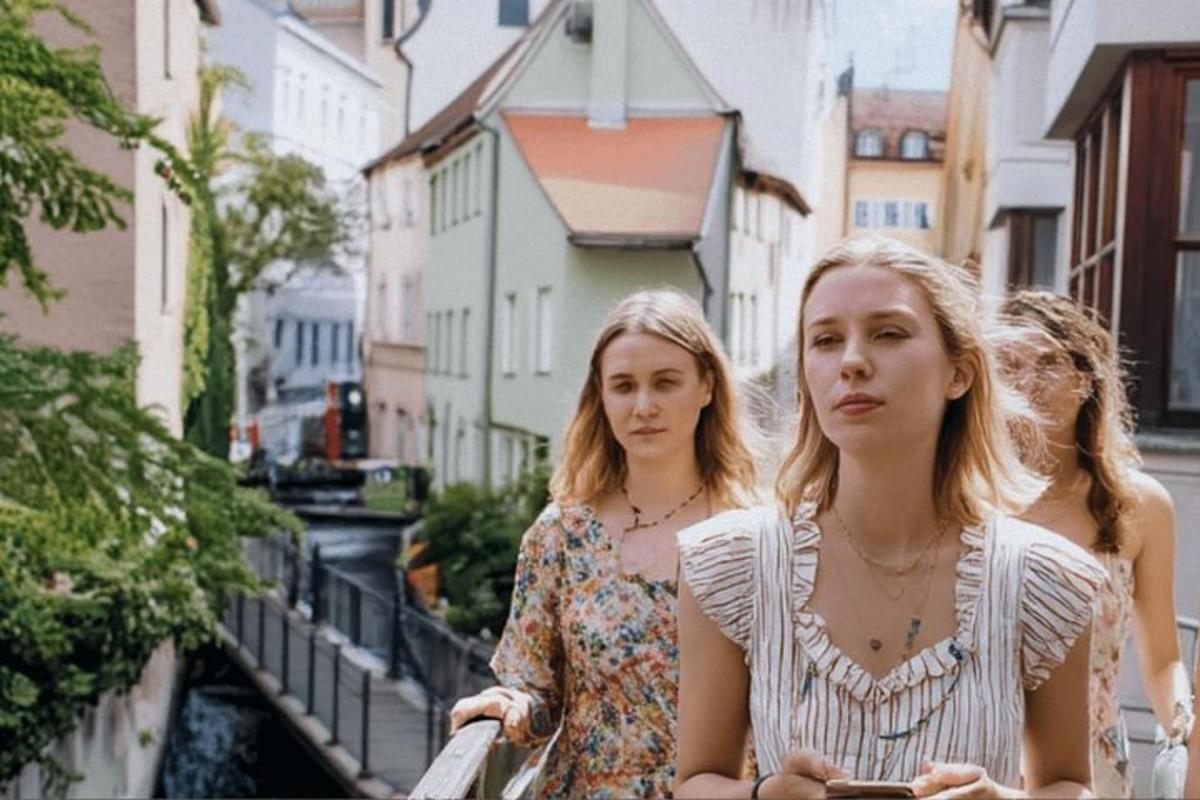 two women walking down a city street