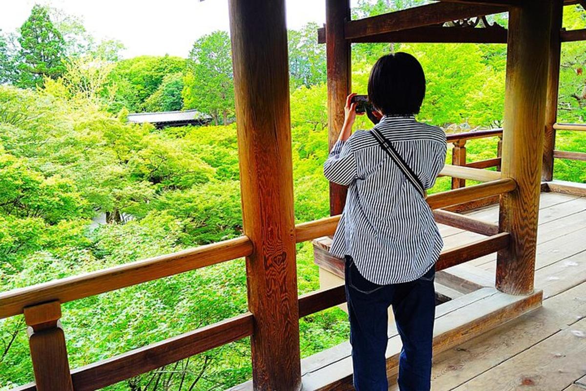 a woman taking a picture of a view from a porch