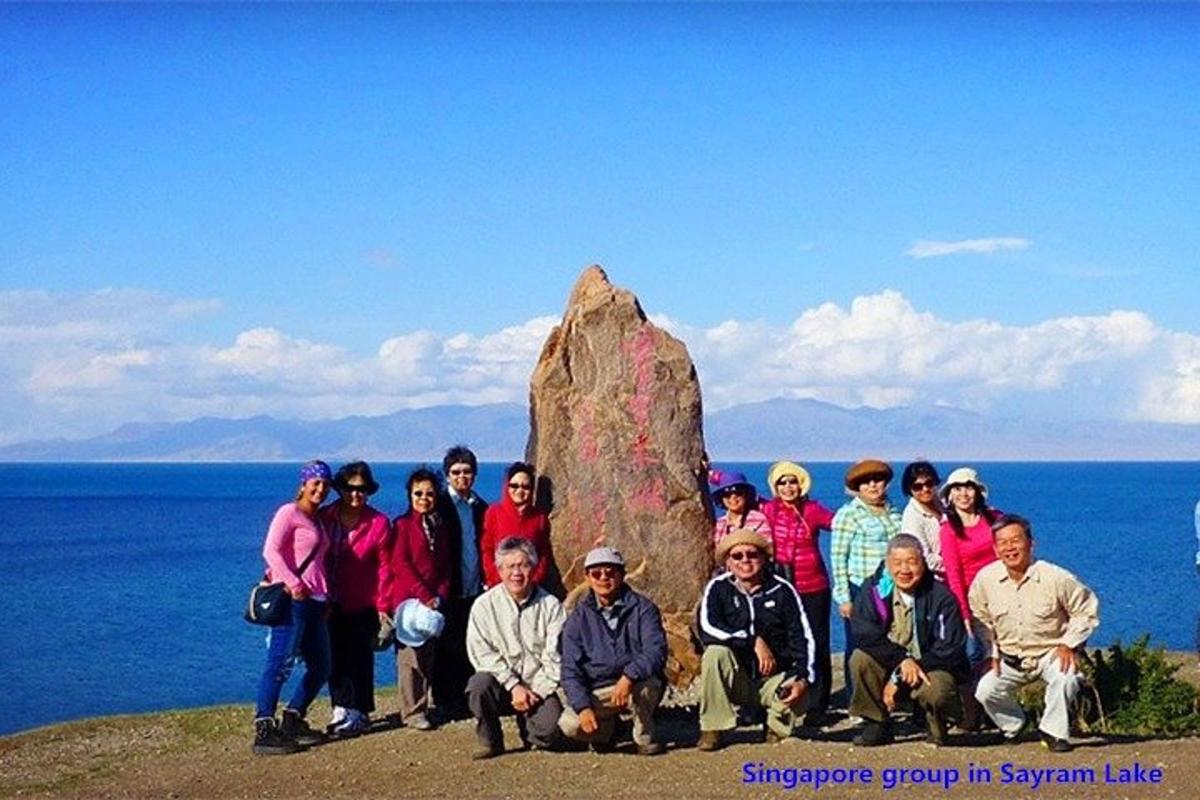 a group of people posing in front of a rock