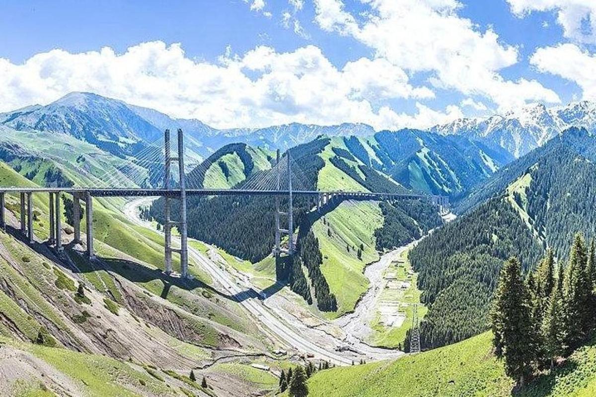 a bridge on top of a mountain with a road
