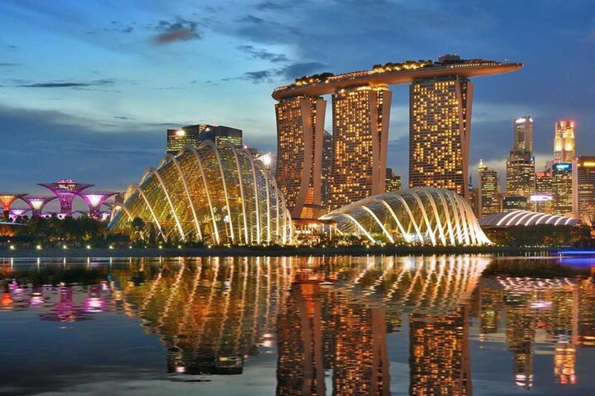a view of a city at night with a reflection in the water