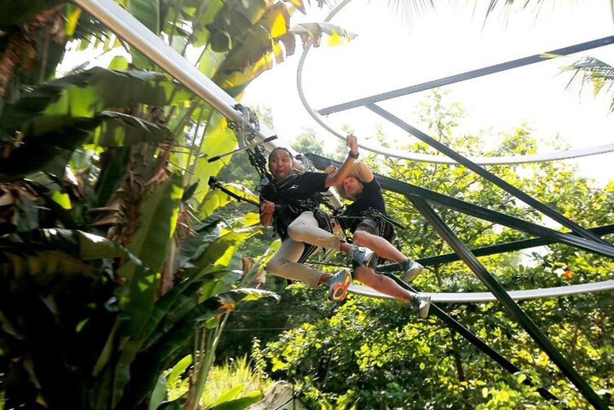 two men are riding on a zip line