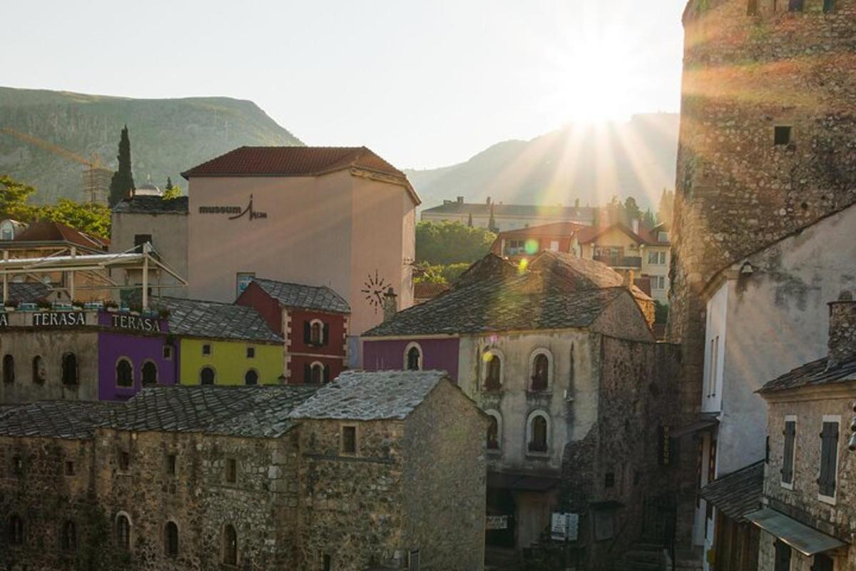 a group of buildings in a city with the sun shining