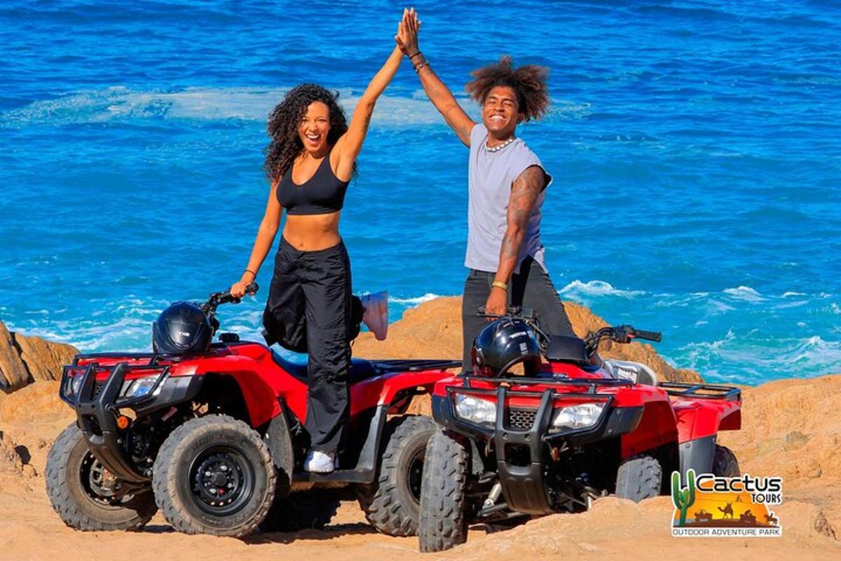 a man and a woman standing on a quad bike on the beach