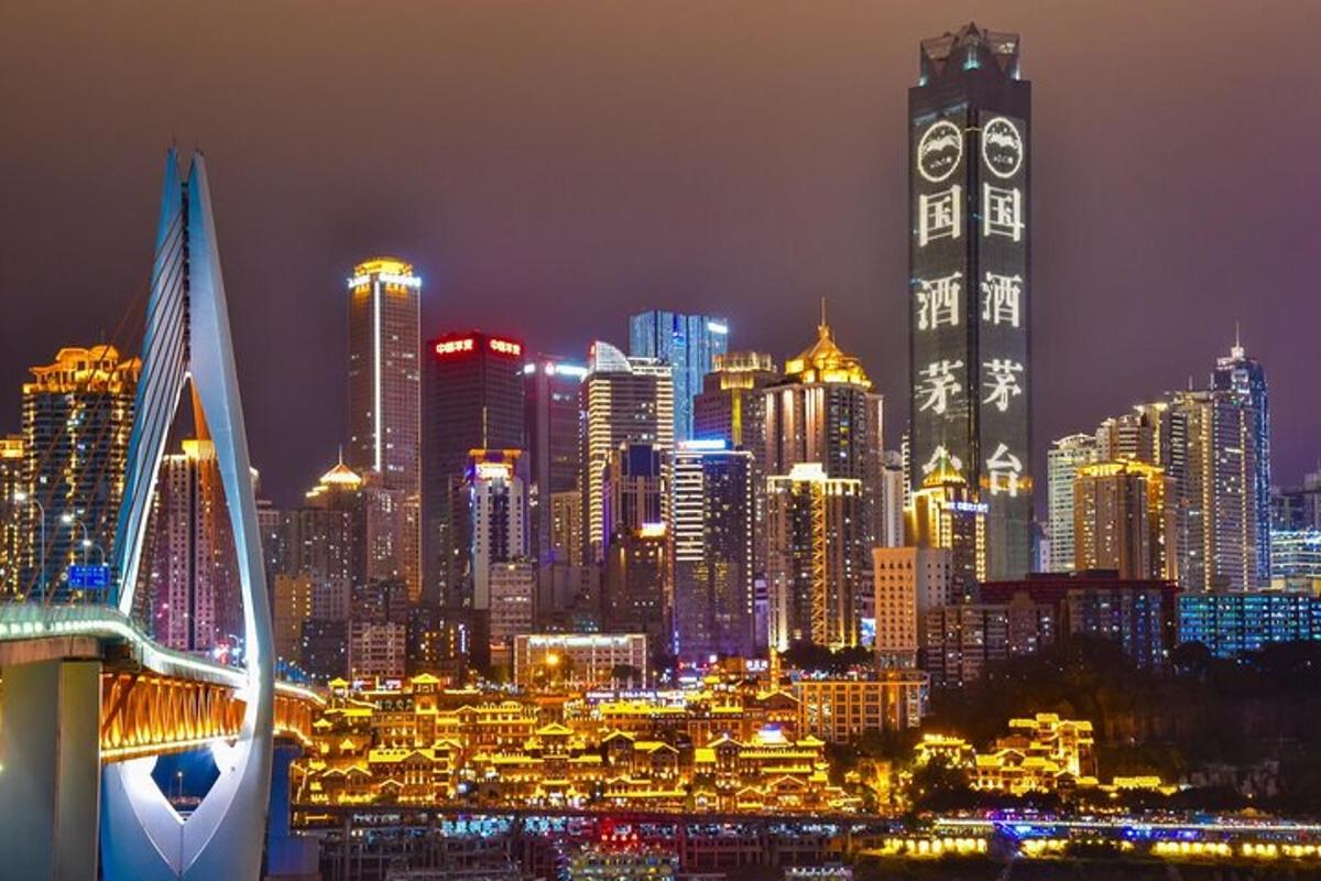 a night view of a city with a clock tower