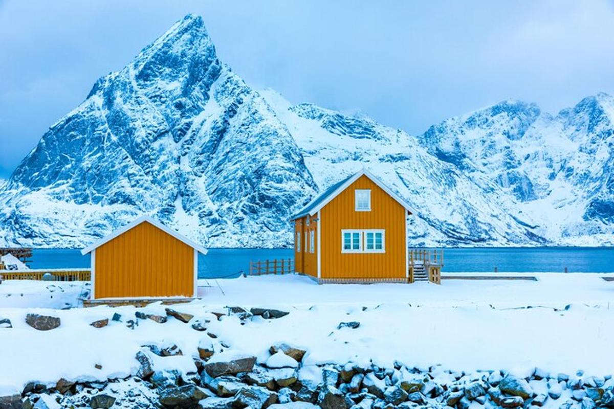 two houses in front of a snowy mountain