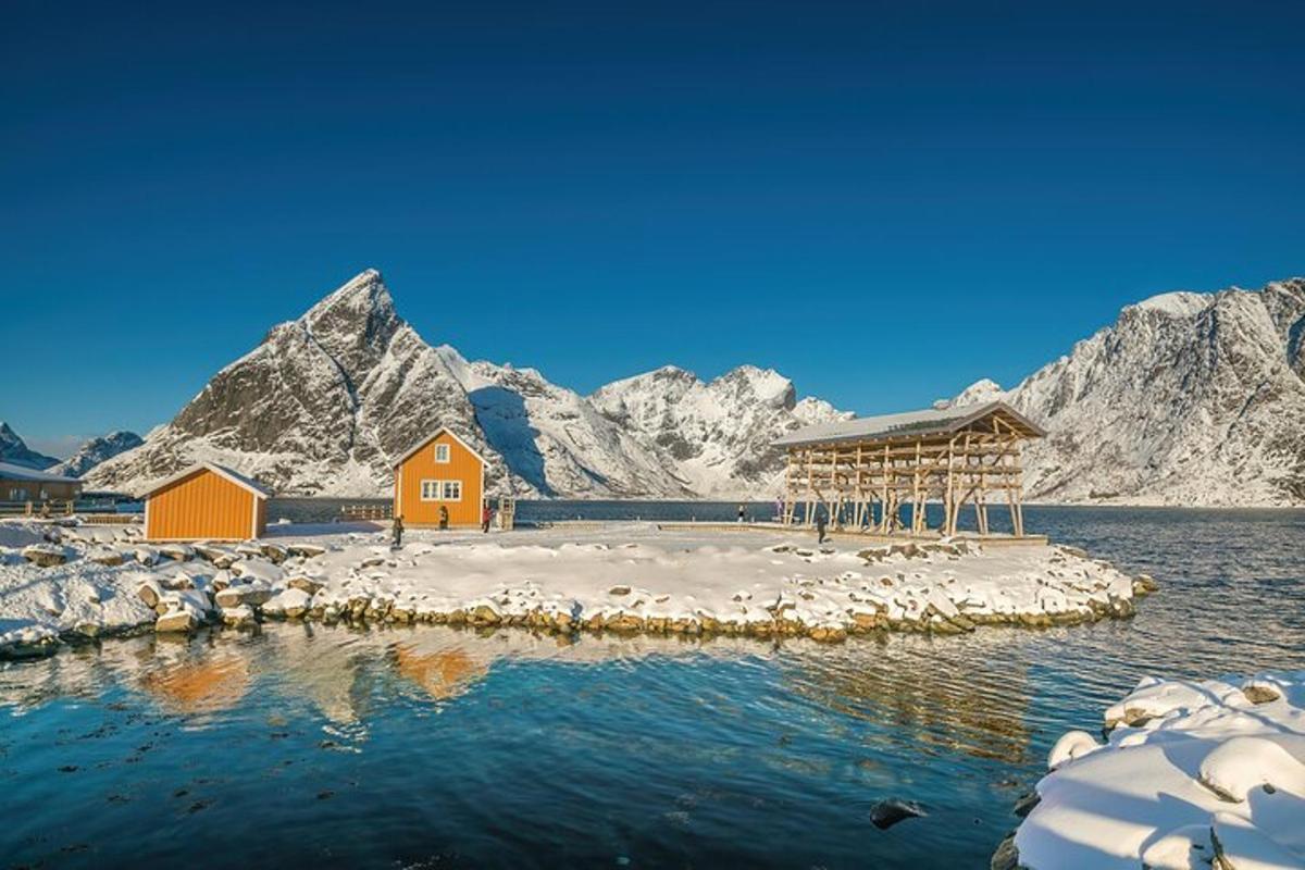 a house on an island in the water with mountains