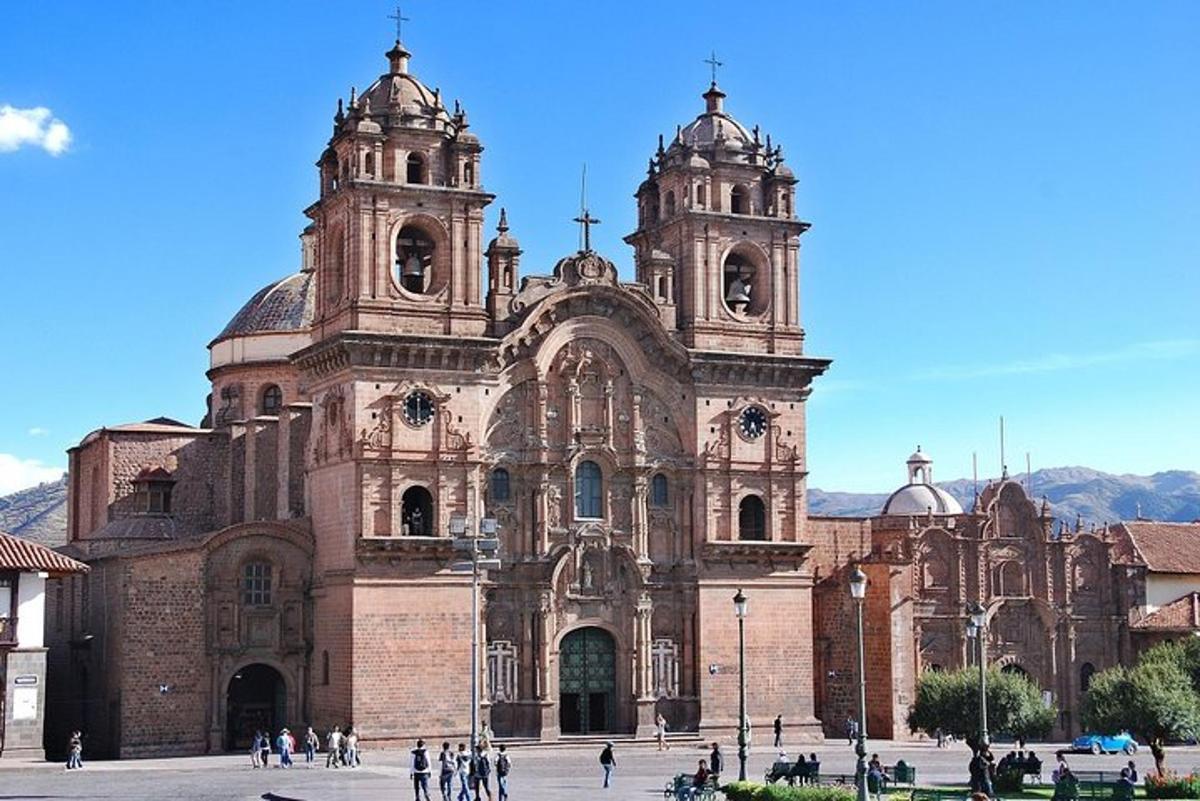 a large cathedral with people standing in front of it