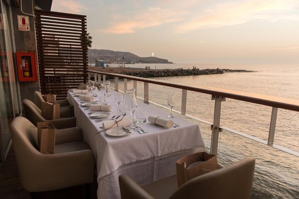 a table on a balcony with a view of the ocean