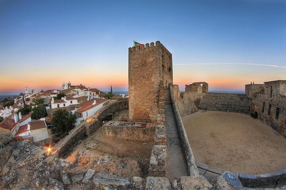 an old castle with a tower on a hill