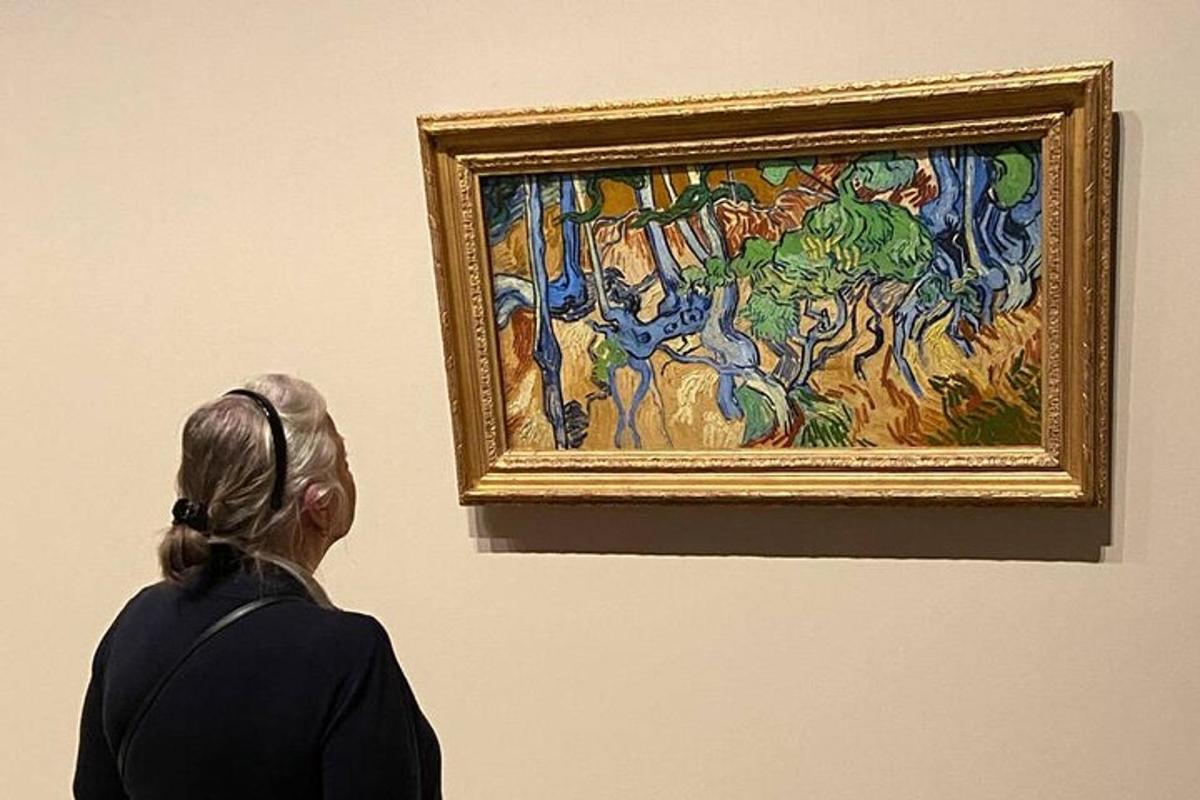 a woman looking at a painting in a museum