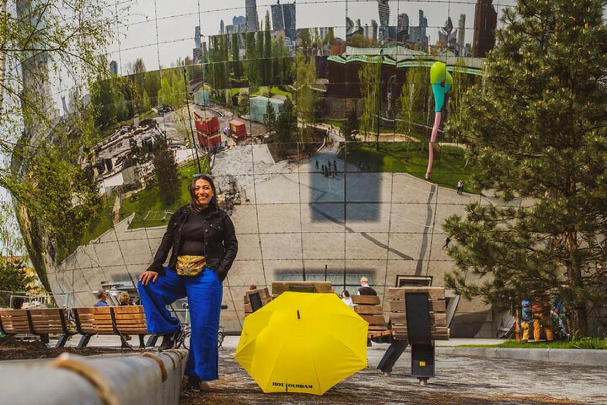 a woman sitting on a bench with a yellow umbrella