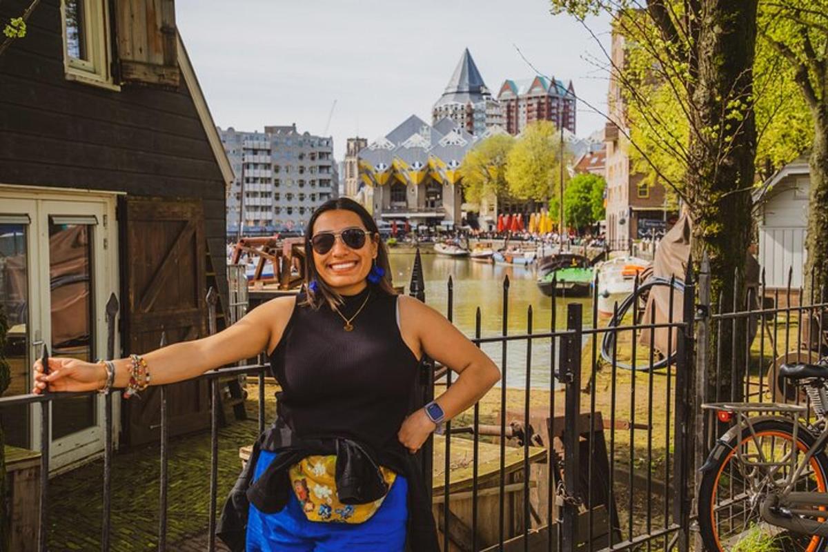 a woman standing next to a fence next to a canal