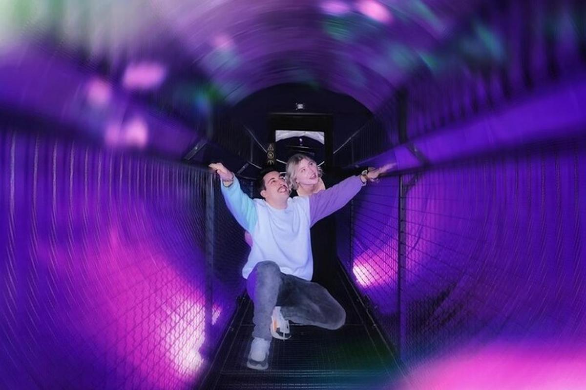 a man and a woman riding down a tunnel