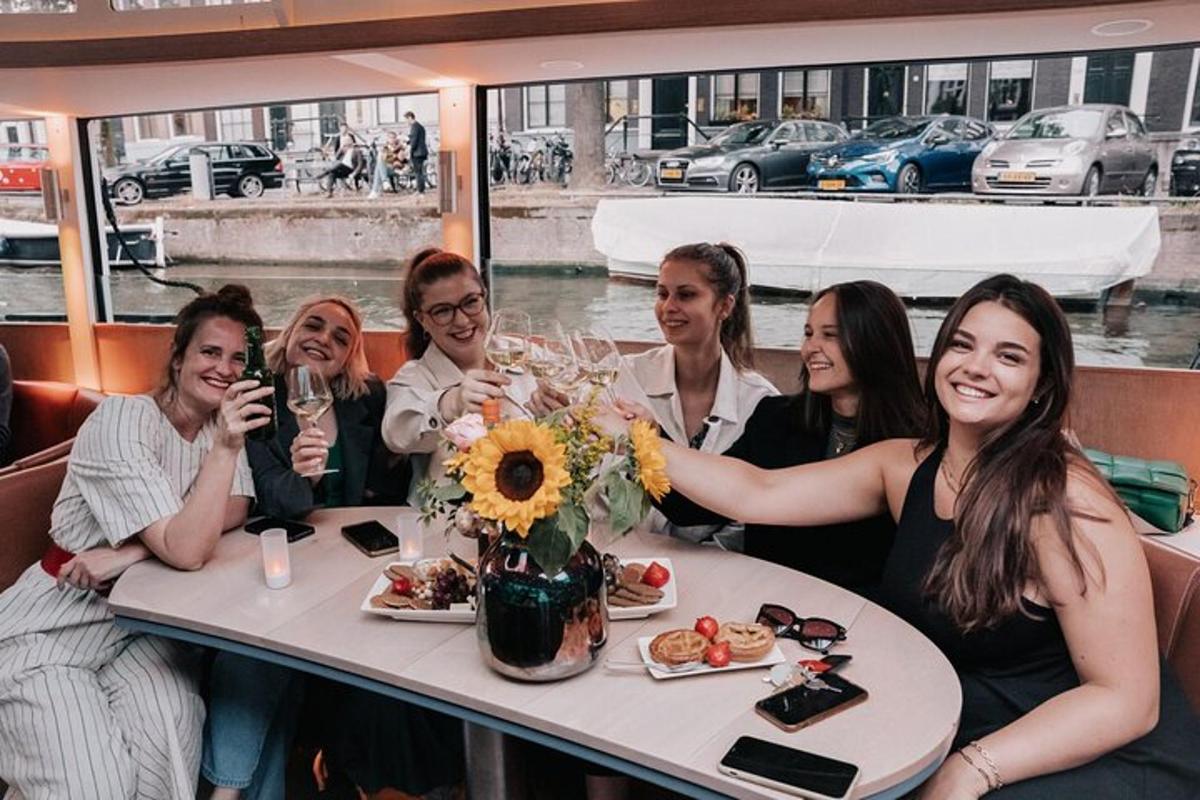 a group of women sitting at a table on a boat